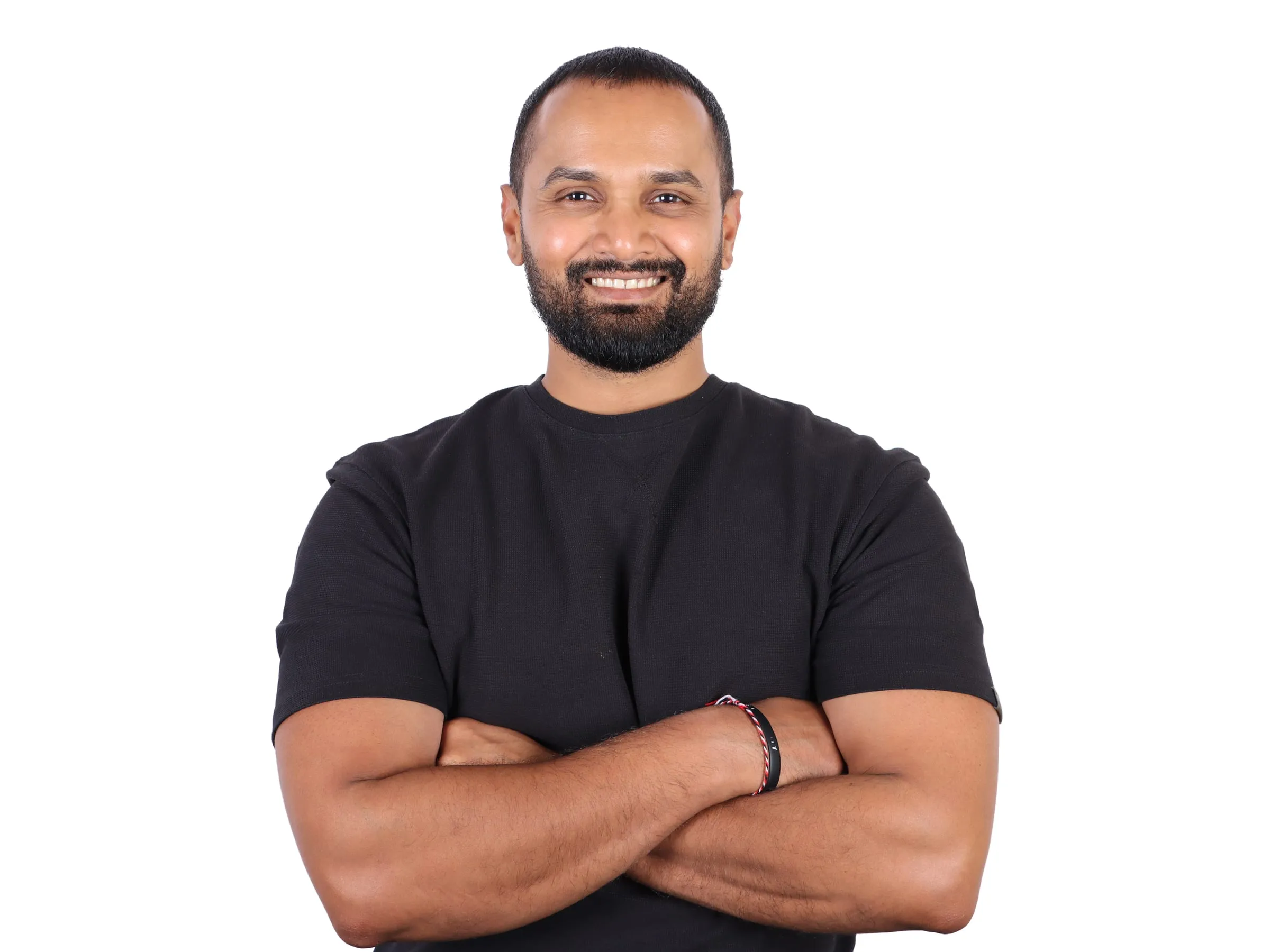 Pranav Shenoy, Mind Body Regulation Coach, standing with his arms folded.